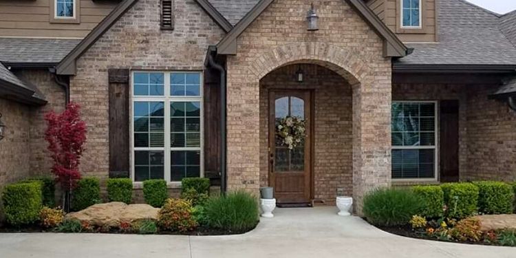 Front entrance to home with plants all recently trimmed.