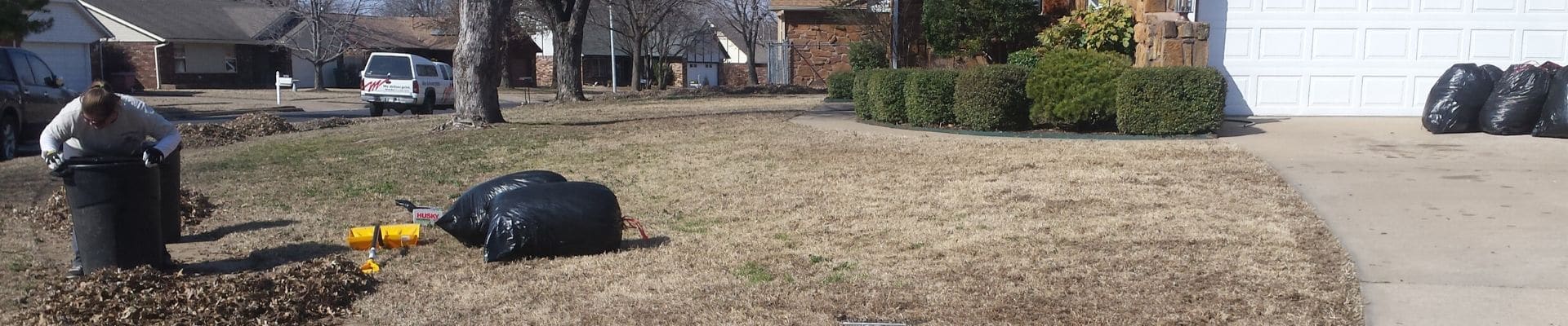 A Sprague's Kik'N Grass employee bagging up leaves to be hauled away.